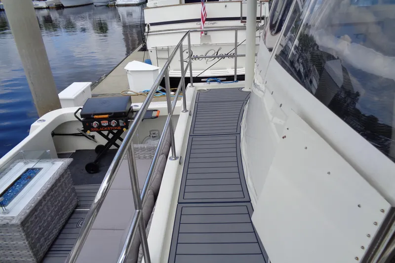 Ivory Lady Yacht Photos Pics 1987 Hatteras 70 Cockpit Motor Yacht deck with grill and seating area.