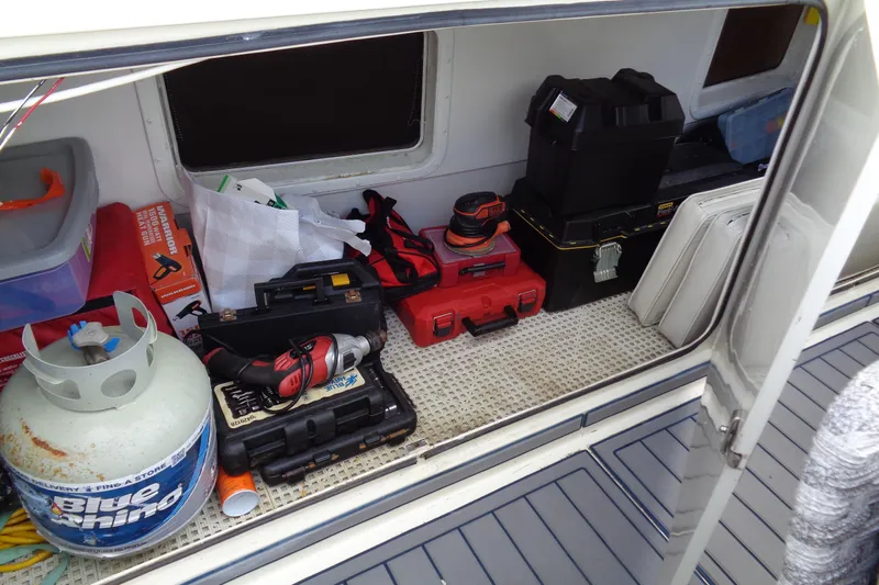 Ivory Lady Yacht Photos Pics Storage compartment of 1987 Hatteras 70 Cockpit Motor Yacht with tools and equipment.