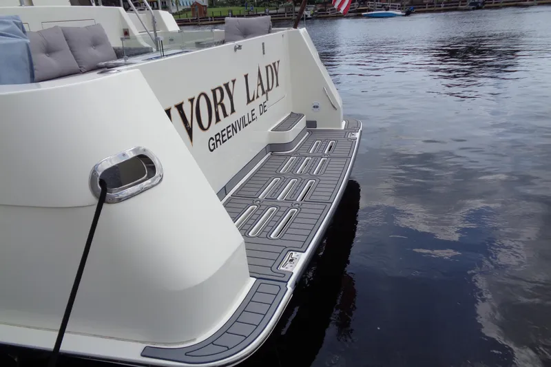 Ivory Lady Yacht Photos Pics 1987 Hatteras 70 Cockpit Motor Yacht docked, featuring sleek design and spacious deck.