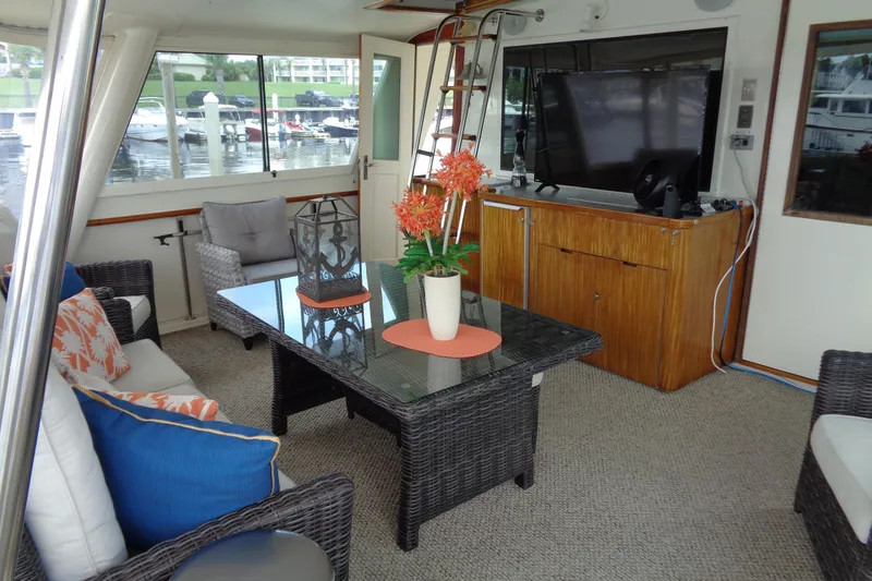 Ivory Lady Yacht Photos Pics Luxurious interior of 1987 Hatteras 70 Cockpit Motor Yacht with elegant seating and decor.