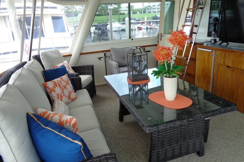 Ivory Lady Yacht Photos Pics Luxurious interior of 1987 Hatteras 70 Cockpit Motor Yacht with elegant seating and decor.