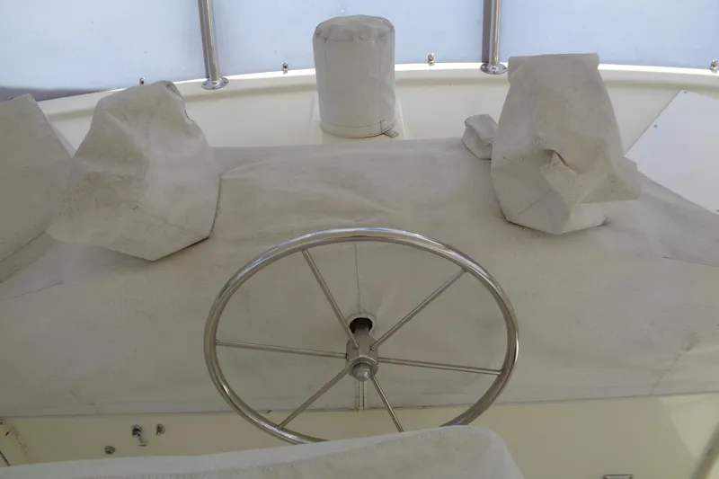 Ivory Lady Yacht Photos Pics Covered helm station of 1987 Hatteras 70 Cockpit Motor Yacht with stainless steel wheel.