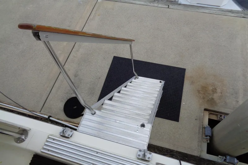 Ivory Lady Yacht Photos Pics Aluminum boarding ladder on 1987 Hatteras 70 Cockpit Motor Yacht, dockside view.