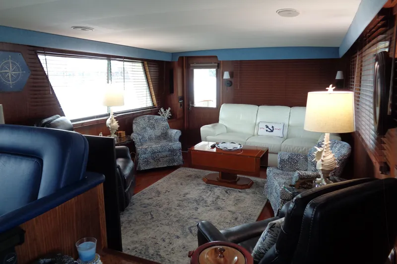 Ivory Lady Yacht Photos Pics Luxurious interior of 1987 Hatteras 70 Cockpit Motor Yacht with elegant seating and decor.