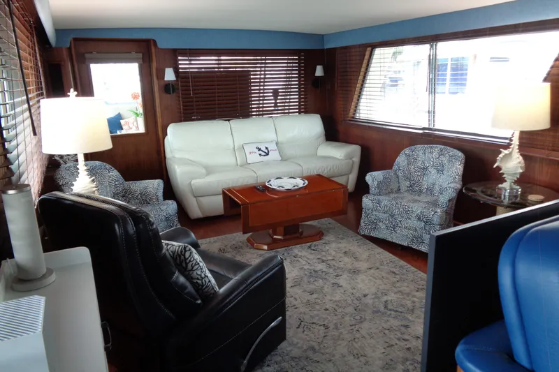 Ivory Lady Yacht Photos Pics Luxurious interior of 1987 Hatteras 70 Cockpit Motor Yacht with elegant seating and decor.