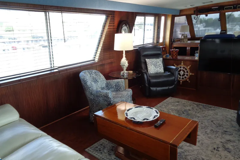 Ivory Lady Yacht Photos Pics Luxurious interior of 1987 Hatteras 70 Cockpit Motor Yacht with elegant seating and decor.