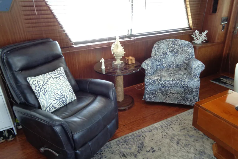 Ivory Lady Yacht Photos Pics Interior of 1987 Hatteras 70 Yacht with leather recliner and patterned armchair.