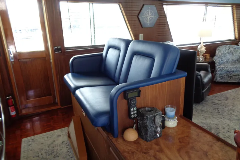 Ivory Lady Yacht Photos Pics Interior of 1987 Hatteras 70 Cockpit Motor Yacht with blue seating and wooden accents.