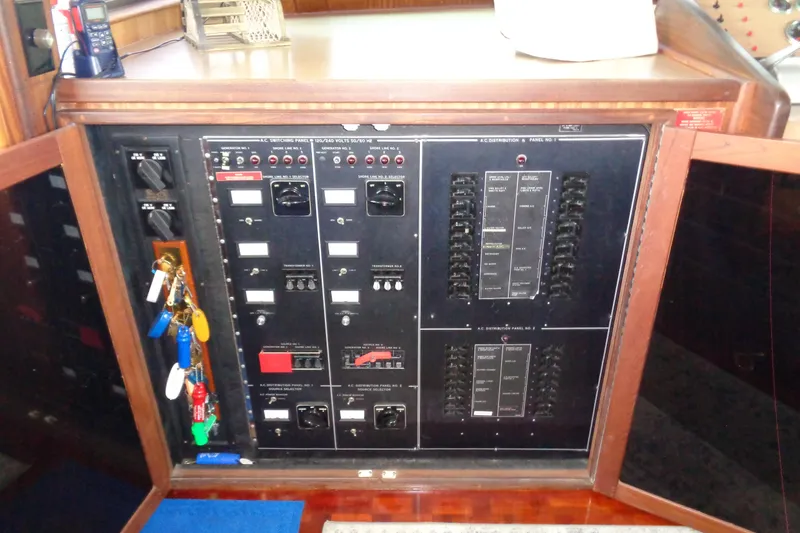 Ivory Lady Yacht Photos Pics Electrical control panel on 1987 Hatteras 70 Cockpit Motor Yacht with keys hanging.