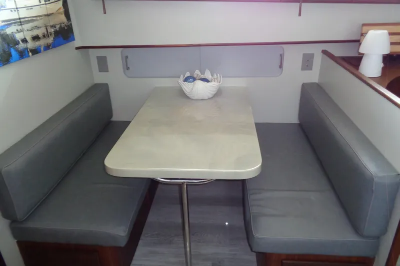 Ivory Lady Yacht Photos Pics Interior dining area of 1987 Hatteras 70 Cockpit Motor Yacht with gray seating.