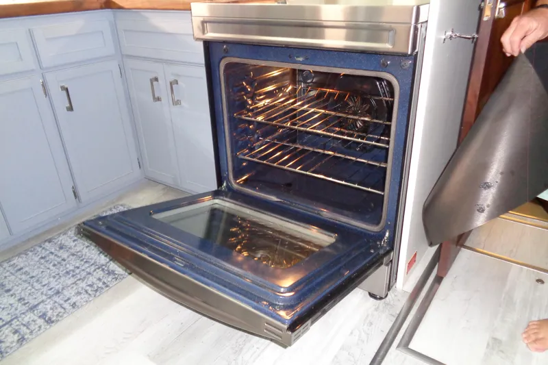 Ivory Lady Yacht Photos Pics Open oven in yacht kitchen, showcasing modern interior and cabinetry.