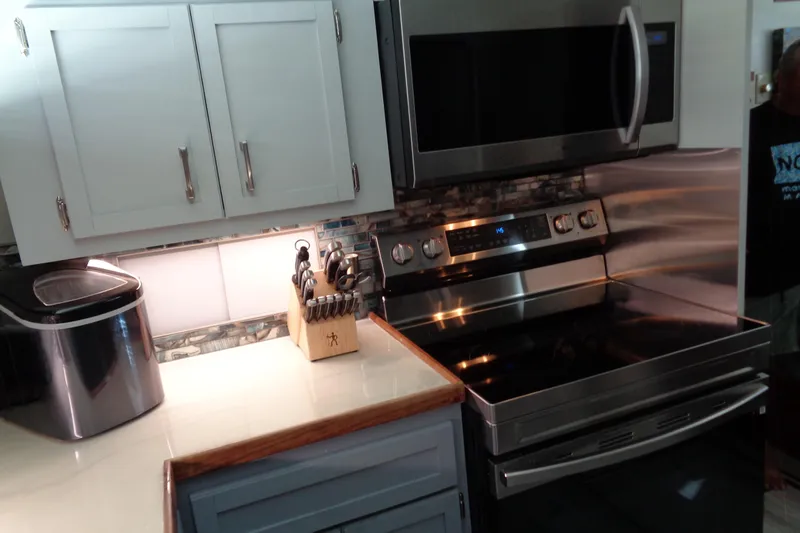 Ivory Lady Yacht Photos Pics Modern kitchen in 1987 Hatteras 70 Cockpit Motor Yacht with stainless steel appliances.