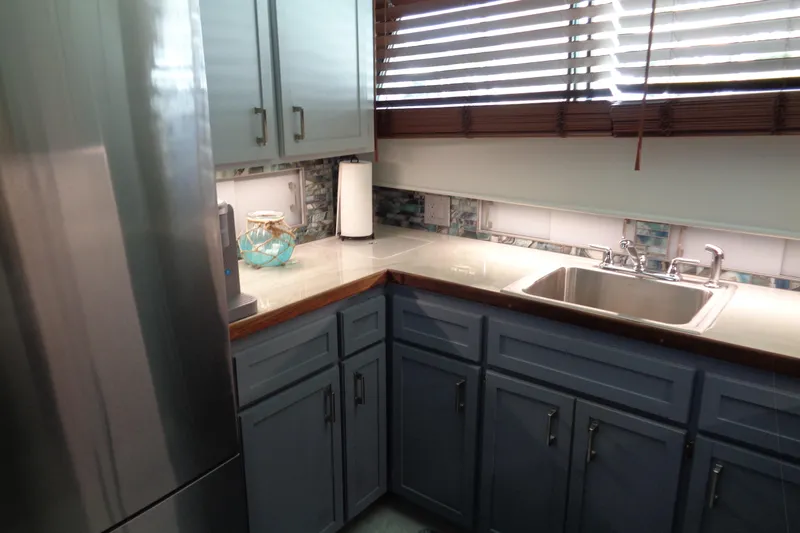 Ivory Lady Yacht Photos Pics Kitchen area of 1987 Hatteras 70 Cockpit Motor Yacht with modern appliances and cabinetry.