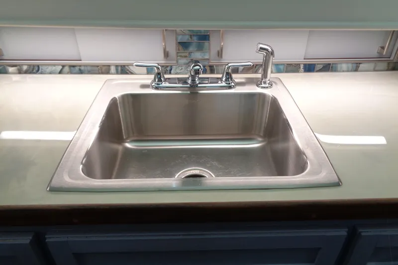 Ivory Lady Yacht Photos Pics Stainless steel sink in 1987 Hatteras 70 Cockpit Motor Yacht kitchen.