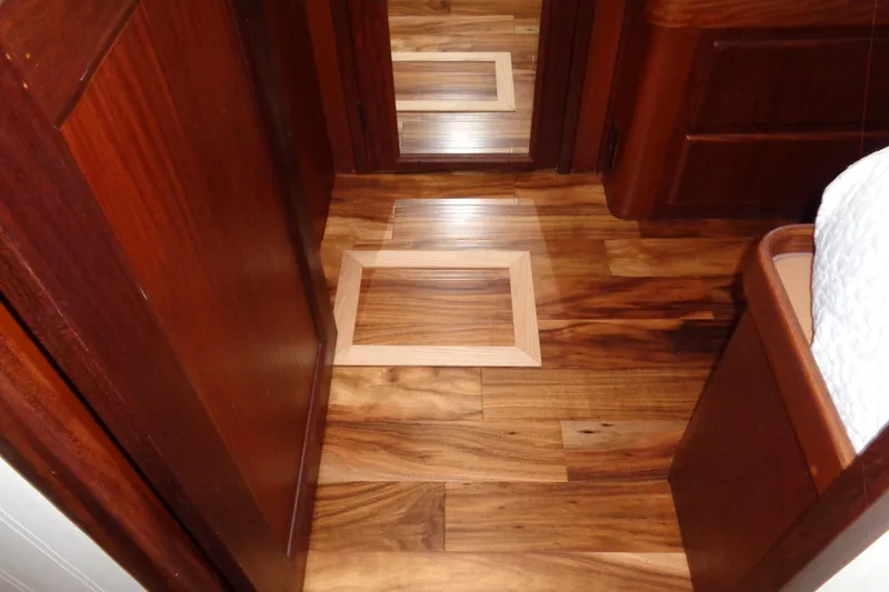 Ivory Lady Yacht Photos Pics Wooden interior flooring of 1987 Hatteras 70 Cockpit Motor Yacht, featuring elegant design.