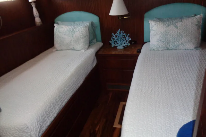 Ivory Lady Yacht Photos Pics Twin beds in a cozy cabin of a 1987 Hatteras 70 Cockpit Motor Yacht.