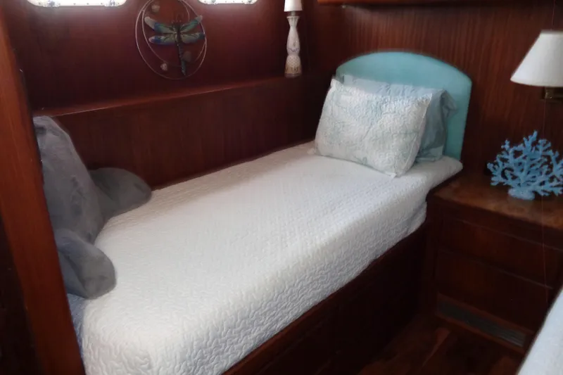 Ivory Lady Yacht Photos Pics Cozy cabin bed in 1987 Hatteras 70 Cockpit Motor Yacht with nautical decor.