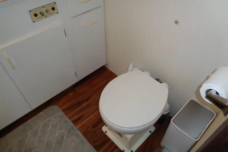Ivory Lady Yacht Photos Pics Bathroom interior of 1987 Hatteras 70 Cockpit Motor Yacht with toilet and cabinetry.