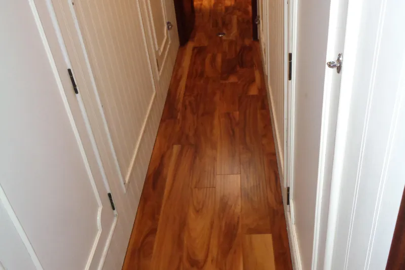 Ivory Lady Yacht Photos Pics Narrow hallway with wooden flooring on a 1987 Hatteras 70 Cockpit Motor Yacht.