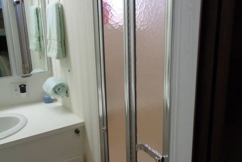 Ivory Lady Yacht Photos Pics Bathroom interior of 1987 Hatteras 70 Cockpit Motor Yacht with shower and sink.