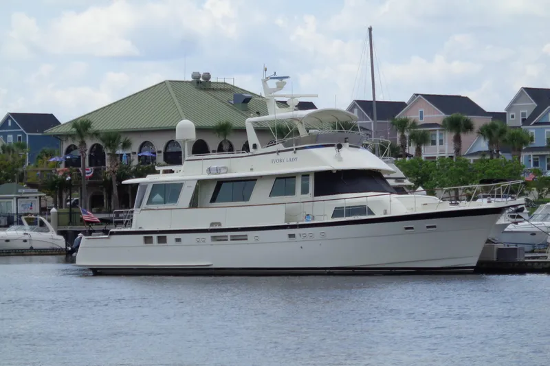 Ivory Lady Yacht Photos Pics 1987 Hatteras 70 Cockpit Motor Yacht docked near waterfront homes.