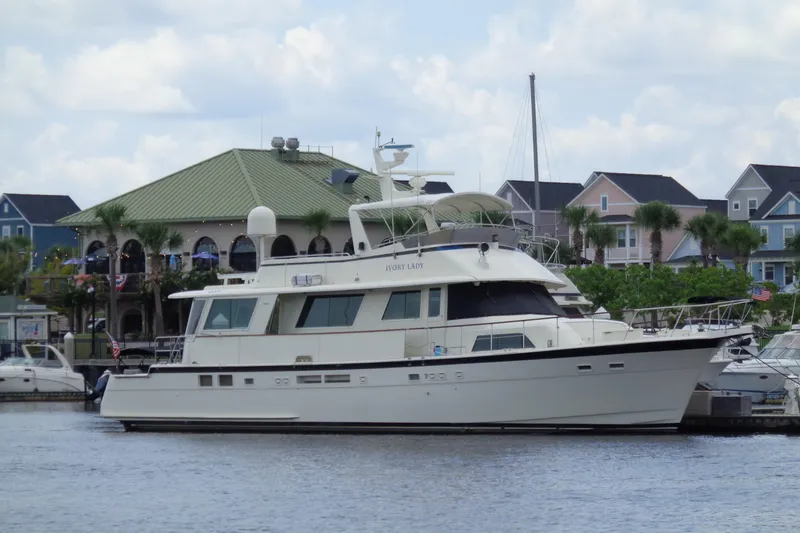 Ivory Lady Yacht Photos Pics 1987 Hatteras 70 Cockpit Motor Yacht docked near waterfront homes.