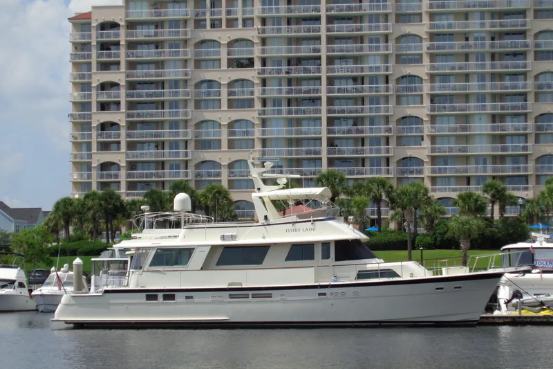 Ivory Lady Yacht Photos Pics 1987 Hatteras 70 Cockpit Motor Yacht docked near waterfront apartments.