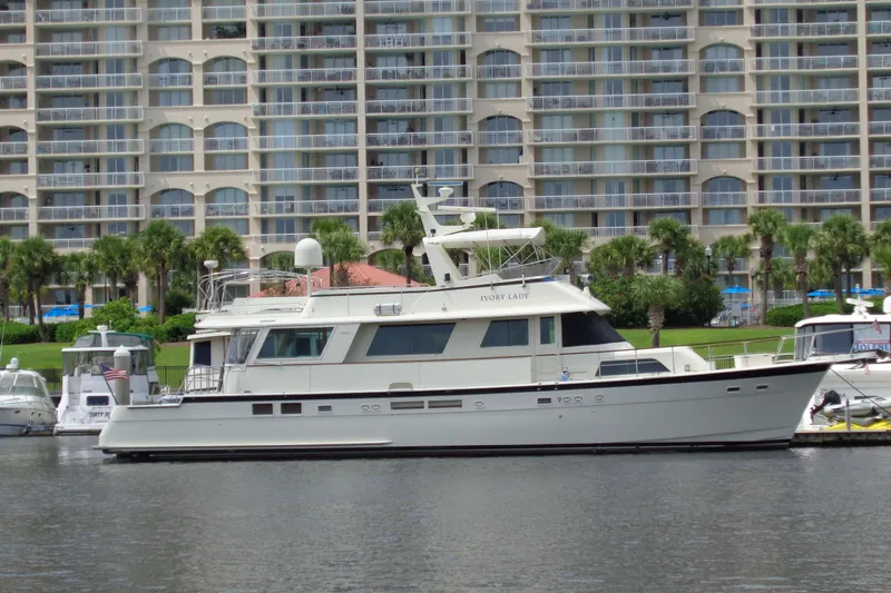 Ivory Lady Yacht Photos Pics 1987 Hatteras 70 Cockpit Motor Yacht docked near waterfront buildings.