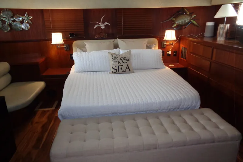Ivory Lady Yacht Photos Pics Luxurious bedroom interior of 1987 Hatteras 70 Cockpit Motor Yacht with elegant decor.
