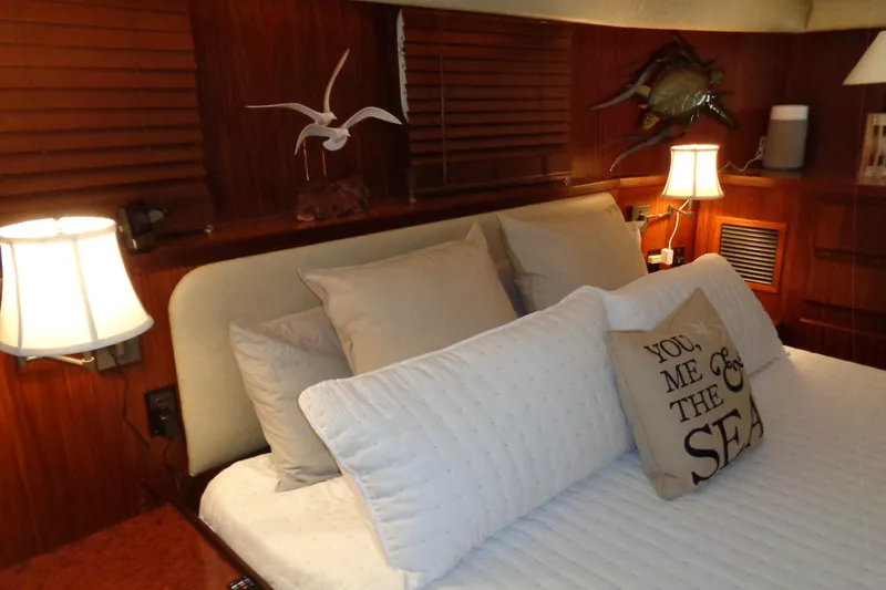 Ivory Lady Yacht Photos Pics Cozy bedroom interior on 1987 Hatteras 70 Cockpit Motor Yacht with nautical decor.