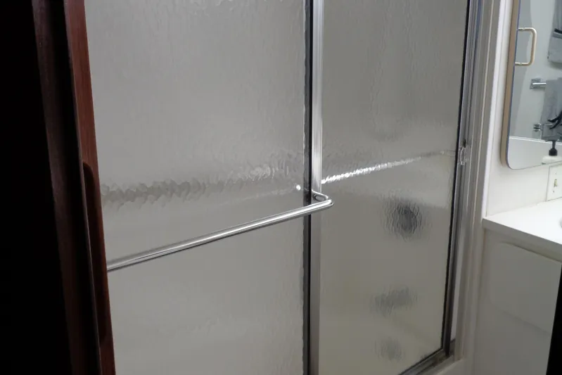 Ivory Lady Yacht Photos Pics Shower area in 1987 Hatteras 70 Cockpit Motor Yacht bathroom with frosted glass door.