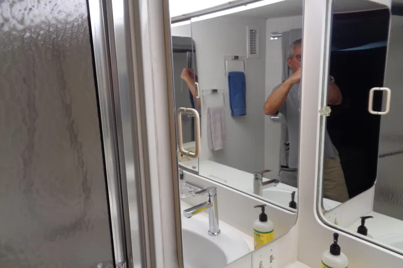 Ivory Lady Yacht Photos Pics Bathroom interior of 1987 Hatteras 70 Cockpit Motor Yacht with mirror and shower.