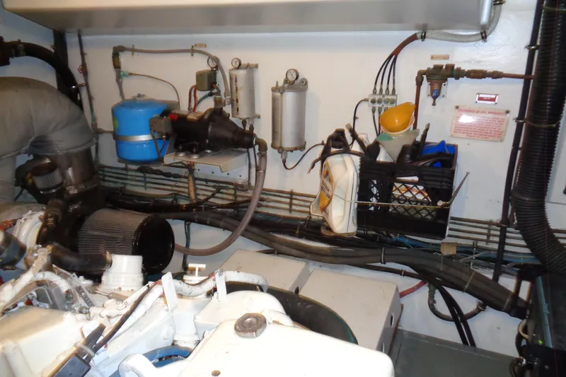 Ivory Lady Yacht Photos Pics Engine room of 1987 Hatteras 70 Cockpit Motor Yacht with various mechanical components.