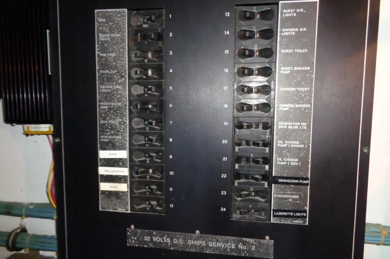 Ivory Lady Yacht Photos Pics Electrical panel on a 1987 Hatteras 70 Cockpit Motor Yacht, showing circuit breakers and labels.