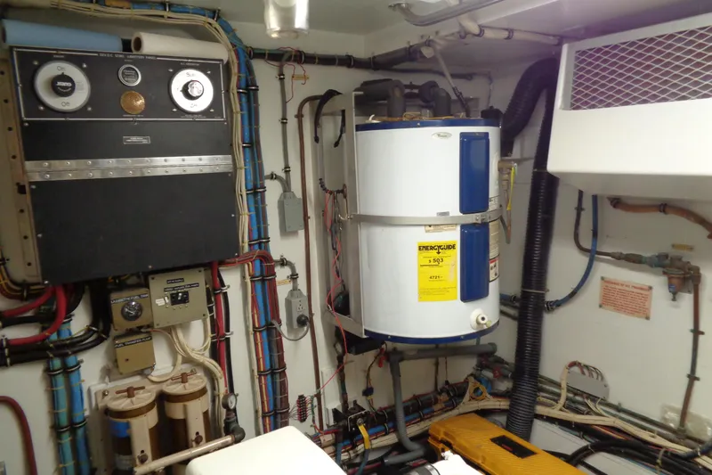 Ivory Lady Yacht Photos Pics Engine room of 1987 Hatteras 70 Cockpit Motor Yacht with electrical panels and water heater.