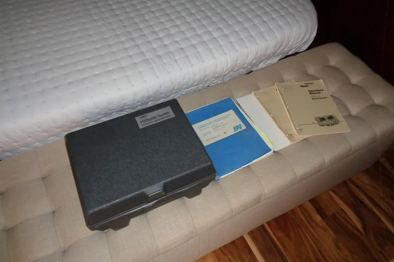 Ivory Lady Yacht Photos Pics Manuals and case for 1987 Hatteras 70 Cockpit Motor Yacht on a cushioned bench.