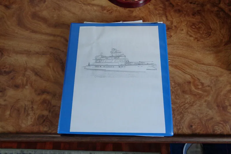 Ivory Lady Yacht Photos Pics Sketch of a 1987 Hatteras 70 Cockpit Motor Yacht on a wooden table.