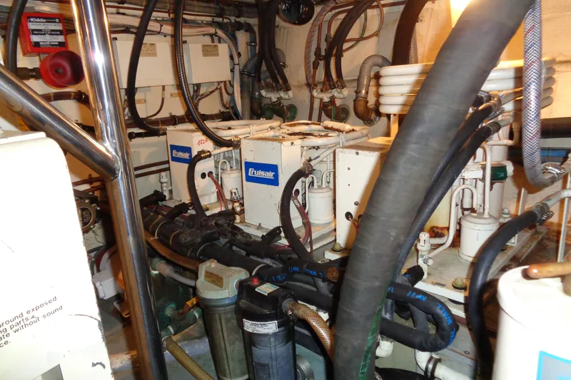 Ivory Lady Yacht Photos Pics Engine room of 1987 Hatteras 70 Cockpit Motor Yacht with mechanical components and wiring.
