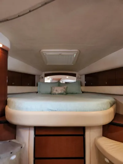  Yacht Photos Pics 2005 Sea Ray 340 Sundancer cabin with cozy bed and elegant wood cabinetry.