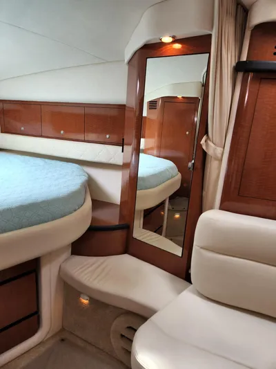  Yacht Photos Pics Interior of 2005 Sea Ray 340 Sundancer yacht with bed, mirror, and wood cabinetry.