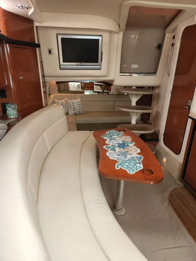  Yacht Photos Pics Luxurious interior of 2005 Sea Ray 340 Sundancer yacht with plush seating and elegant decor.
