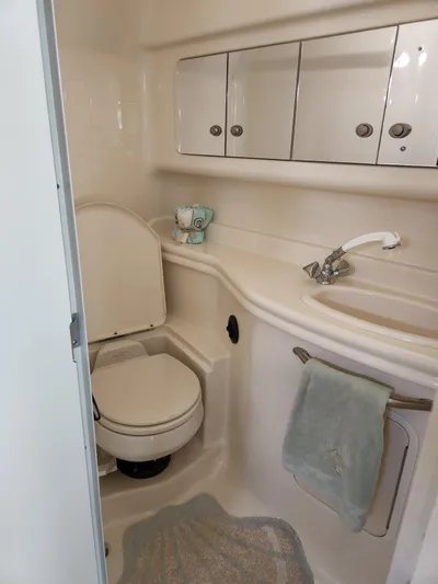  Yacht Photos Pics 2005 Sea Ray 340 Sundancer bathroom with toilet, sink, and storage cabinets.