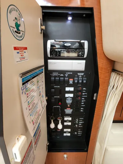  Yacht Photos Pics Electrical panel inside 2005 Sea Ray 340 Sundancer boat, featuring control switches and stereo system.