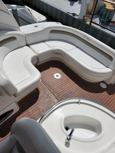  Yacht Photos Pics 2005 Sea Ray 340 Sundancer boat interior with white seating and wooden deck.