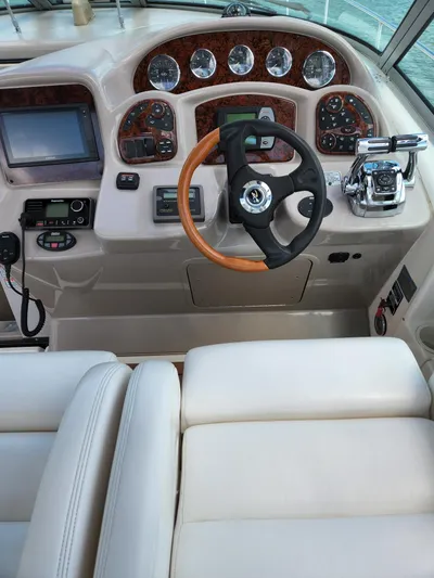  Yacht Photos Pics 2005 Sea Ray 340 Sundancer helm with steering wheel, gauges, and navigation controls.