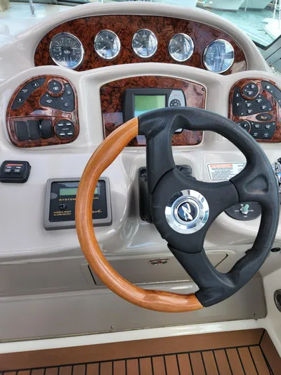  Yacht Photos Pics 2005 Sea Ray 340 Sundancer helm with wood-accented steering wheel and control panel.