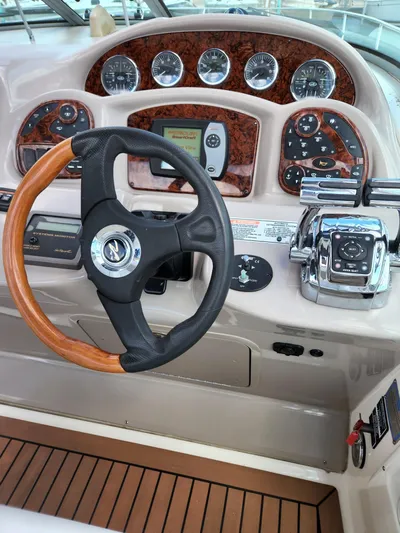  Yacht Photos Pics 2005 Sea Ray 340 Sundancer helm with wood-accented steering wheel and control panel.