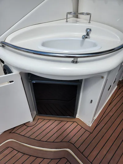  Yacht Photos Pics 2005 Sea Ray 340 Sundancer interior with sink and wooden flooring.