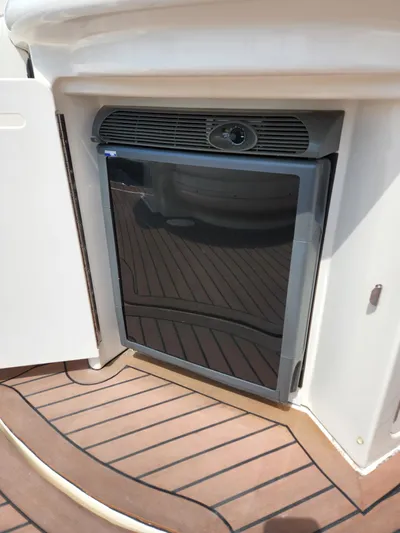  Yacht Photos Pics Built-in refrigerator on 2005 Sea Ray 340 Sundancer yacht, featuring teak flooring.