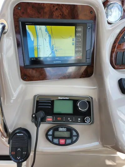  Yacht Photos Pics 2005 Sea Ray 340 Sundancer dashboard with Garmin GPS, Raymarine radio, and Clarion audio controls.